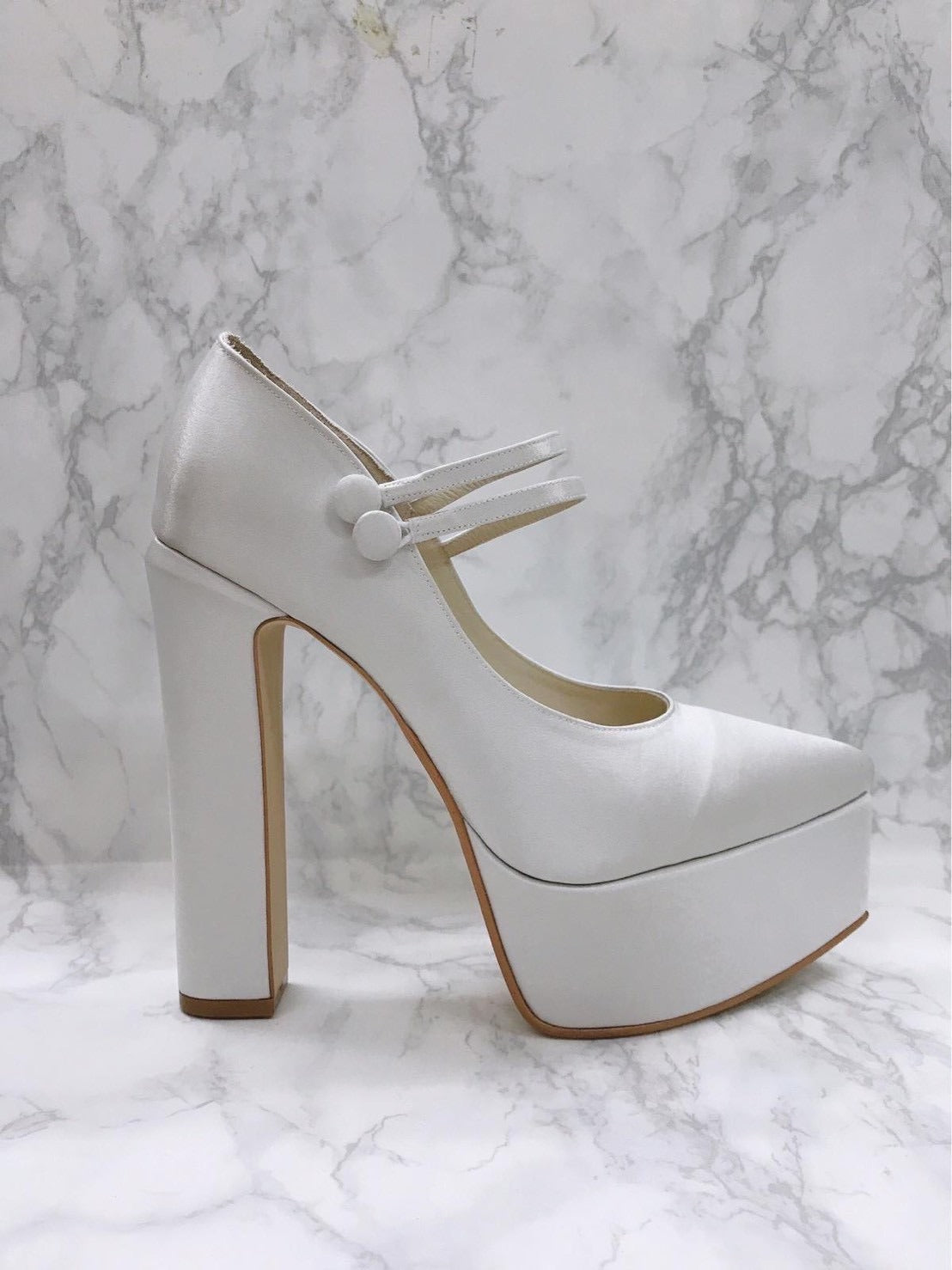 The Celeste Mary Jane platform pumps with a 6-inch heel, in light silver