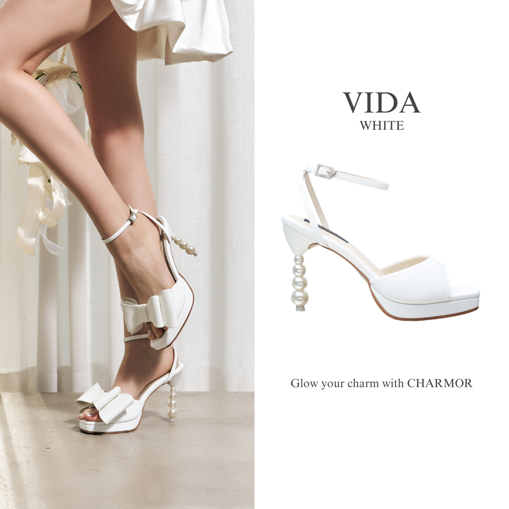 Model wearing The Vida pearl platform heels in white