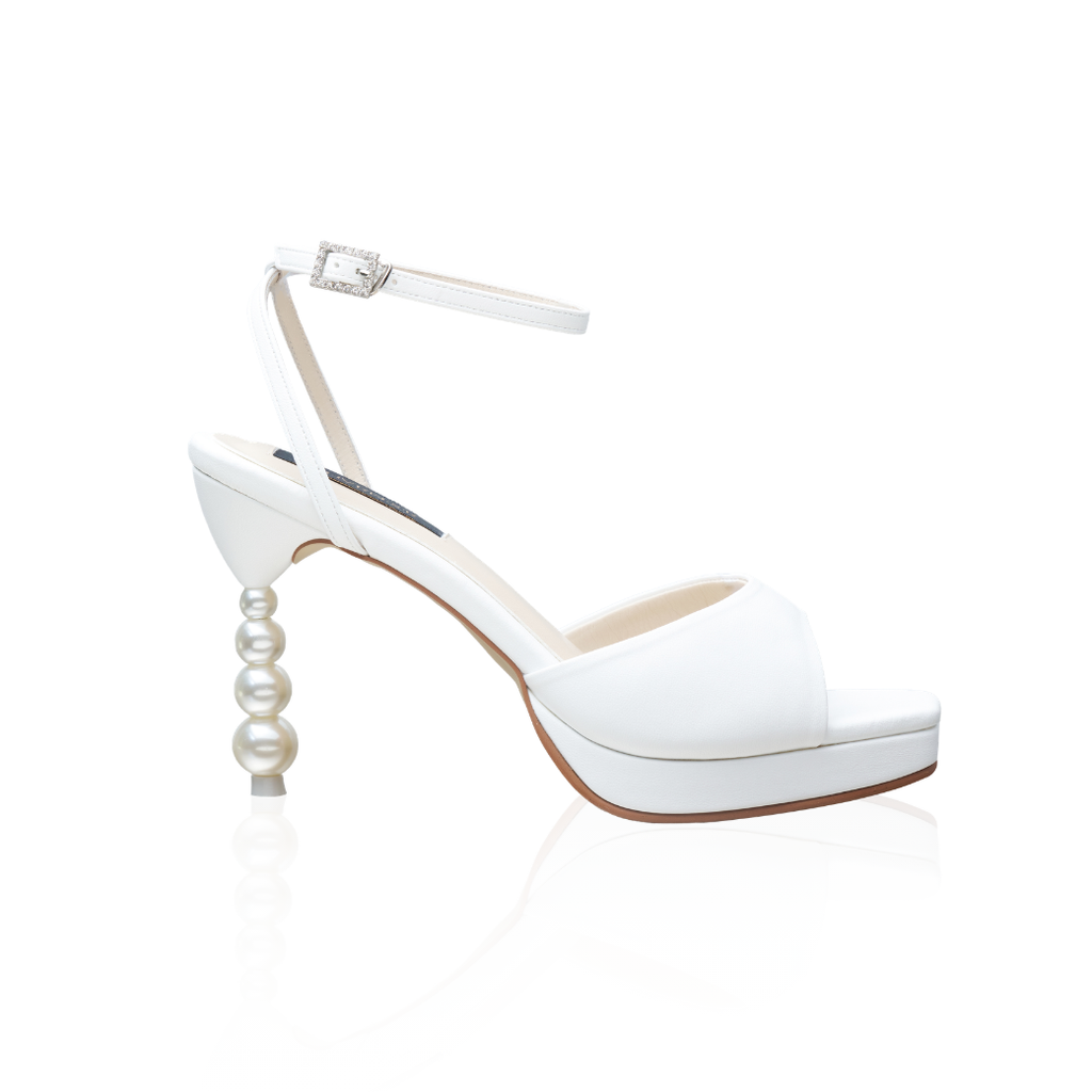 The Vida pearl-heel platform sandals with a 4-inch heel and ankle strap, in white